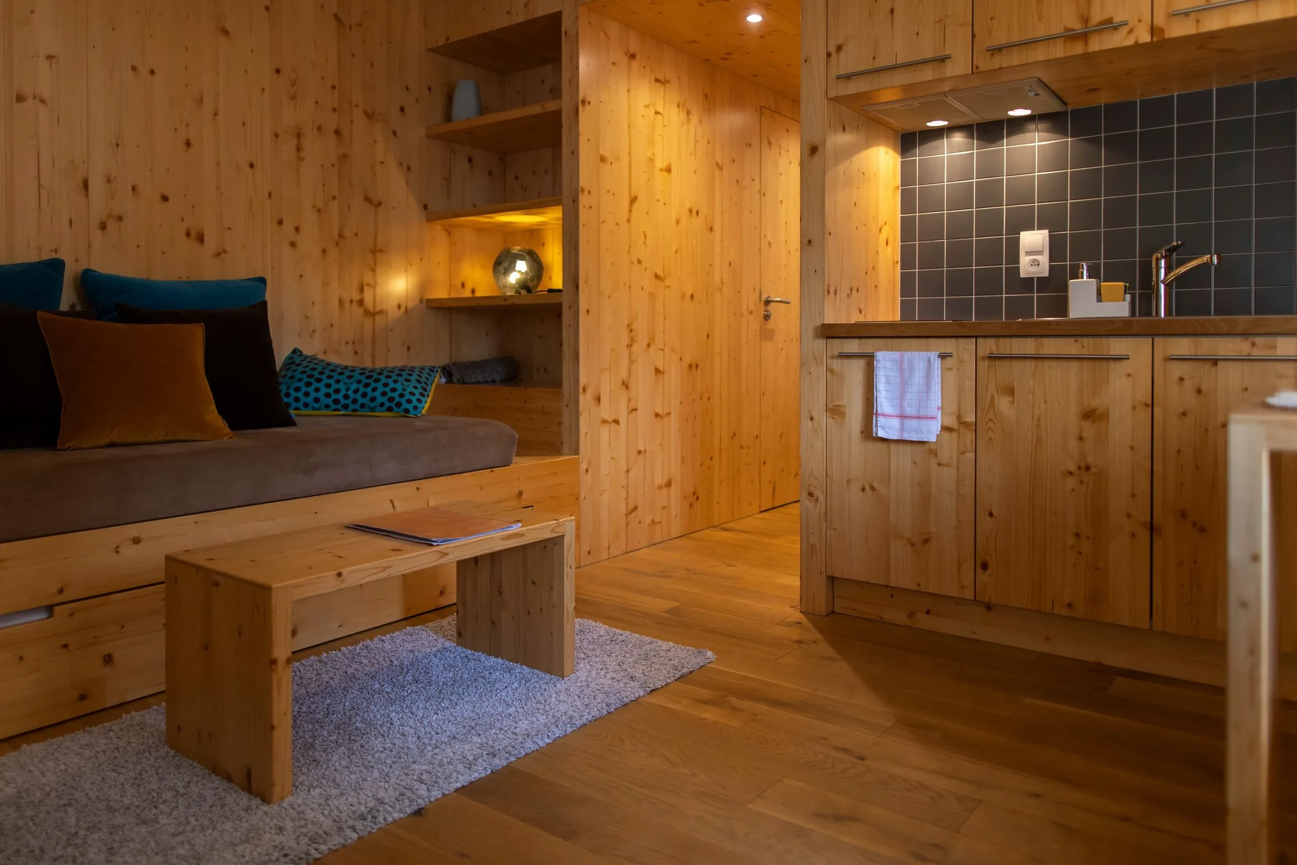 Cozy wooden interior with couch and kitchen