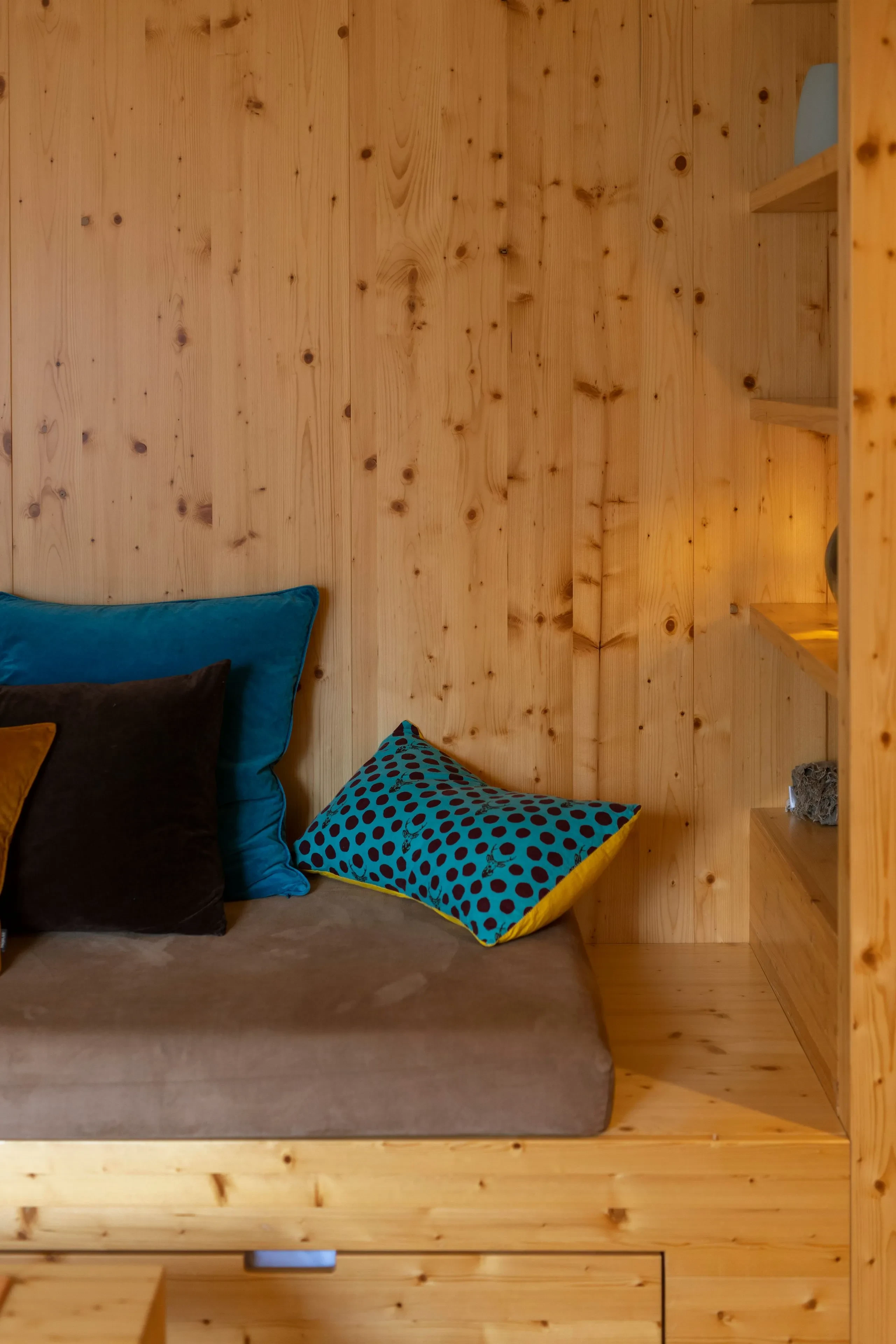 Cozy wooden nook with colorful pillows