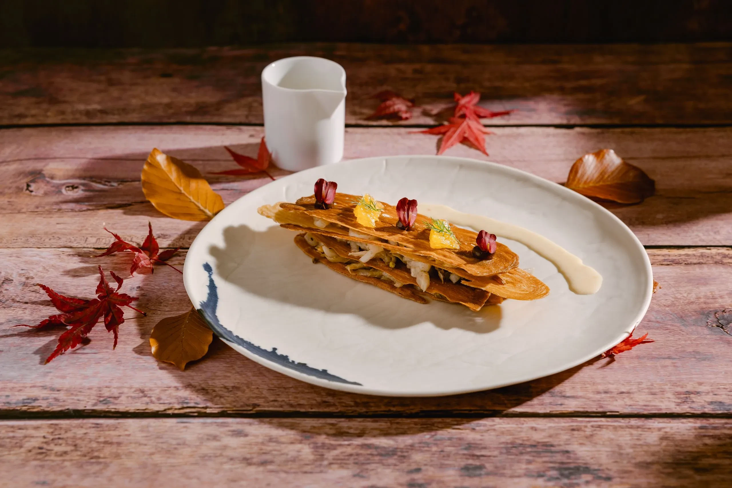 Gourmet dessert on a rustic wooden table.