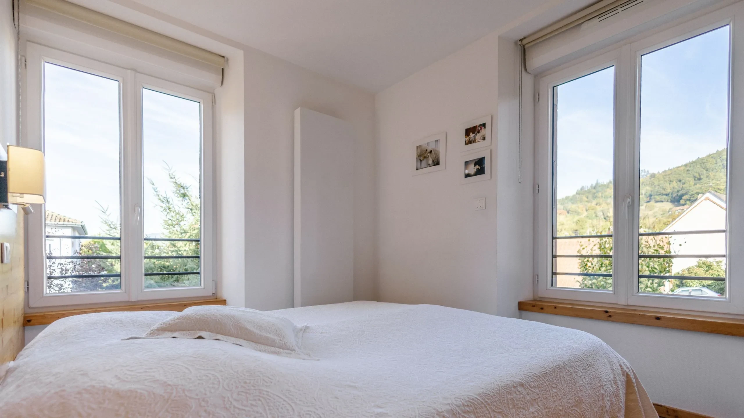 Bright bedroom with large windows and mountain view